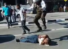 Sri Lankan police officer harassing a man