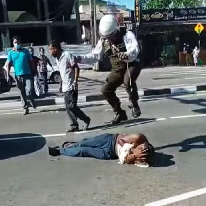 Sri Lankan police officer harassing a man